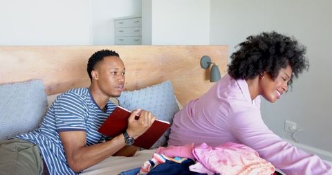 African American Couple Packing Suitcase for Travel Adventure at Home