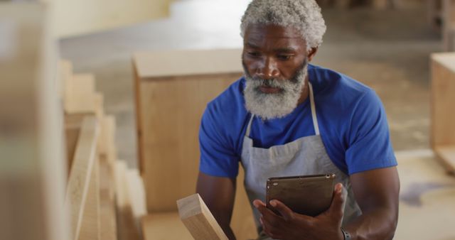 Experienced Carpenter Reviewing Measurement with Tablet - Download Free Stock Images Pikwizard.com