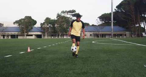 Soccer player perfecting dribbling skills on sunny field
