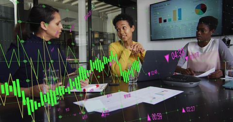 Diverse Female Colleagues Analyzing Data in Office Meeting