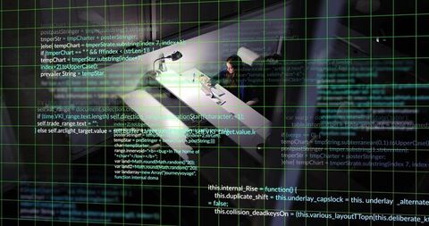 Woman coding on laptop at overhead desk with green code grid overlay and lamp glow