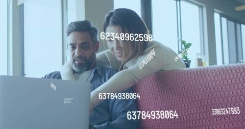 Couple Relaxing Together at Laptop in Cozy Living Room