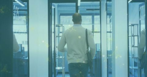 Businessman walking through stylish corporate office corridor