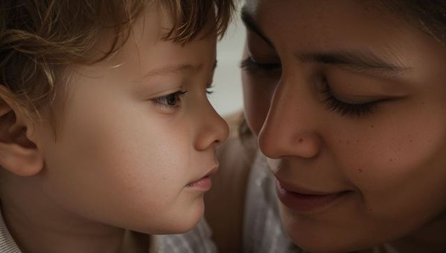 Tender close portrait of mother and toddler sharing intimate gaze and gentle affection