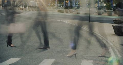 Blurred motion of pedestrians crossing busy urban crosswalk