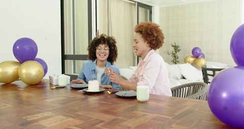 African American Friends Celebrating Birthday with Cake and Balloons at Home Gathering