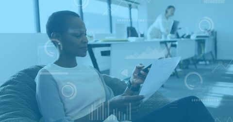 Businesswoman Analyzing Data and Discussing on Smartphone