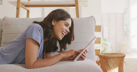 Woman Relaxing at Home Using Digital Tablet by Daylight - Download Free Stock Images Pikwizard.com