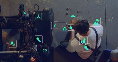 Mechanic fine-tuning vehicle axle with digital icons overlay