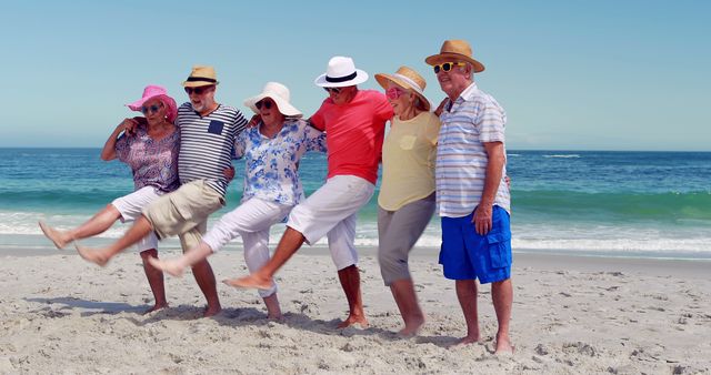 Senior friends in colorful outfits are standing on sandy beach by the ocean, lifting one leg up and smiling. Ideal for promoting senior travel destinations, summer vacation, leisure activities for seniors, friendship themes, and outdoor wellness.
