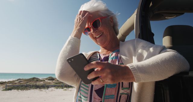 Senior Woman Enjoying Beach Vacation While Using Smartphone - Download Free Stock Images Pikwizard.com