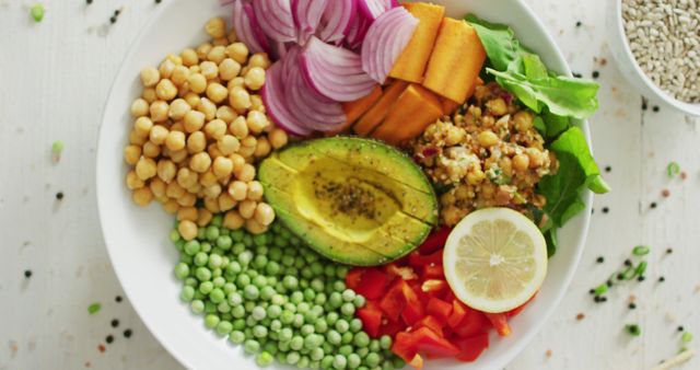 Brightly colored vegan Buddha bowl featuring fresh vegetables like avocado, chickpeas, peas, and sweet potato. Ideal for promoting healthy eating, vegan recipes, plant-based diets, and healthy lifestyle concepts. Suitable for food blogs, cookbook illustrations, and health and wellness websites.