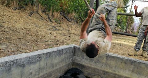 Soldier performing rope obstacle course exercise military training