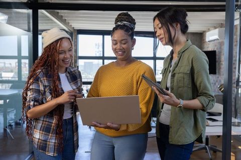 Diverse Women Collaborating in Modern Office Loft