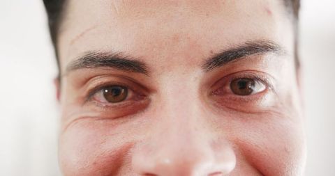 Close-up Portrait of Laughing Man's Brown Eyes