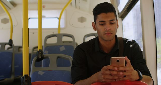 Happy biracial man using smartphone on sunny city bus during commute - Download Free Stock Images Pikwizard.com