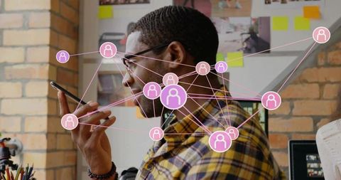 Speaking into smartphone with social network nodes connecting teammates in workspace