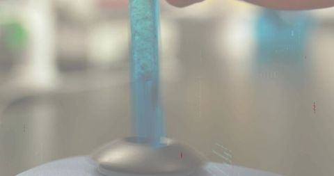 Translucent blue rod resting in matte dome base laboratory macro closeup with bokeh