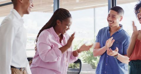 Engaged Colleagues Celebrating Success in Modern Office