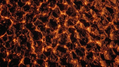 Glowing lava crevices on rugged volcanic landscape