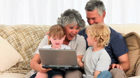 Happy Family Bonding While Using Laptop at Home