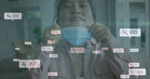 Korean man pulling surgical mask down wearing pink shirt with floating digital ui overlays