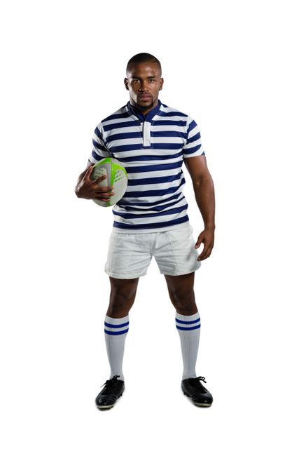 Portrait of sportsman wearing sports uniform holding rugby ball while standing against white background