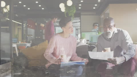 Diverse Professionals Discussing Reports in Modern Office