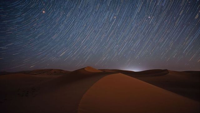 Star Trails Creating Beautiful Patterns over Peaceful Desert Nightscape