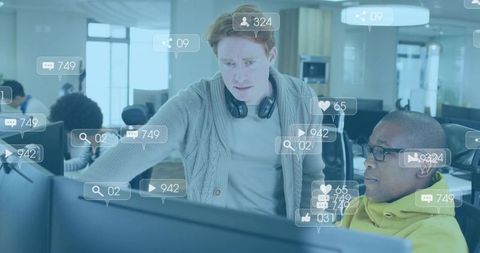 Redhead Mentor Guiding Colleague Over Monitors with Floating Social Analytics and Dashboards