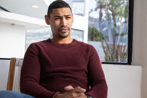 Professional Man Contemplates While Gazing Out Modern Office Window