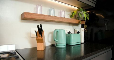 Mint green kitchen appliances in modern interior