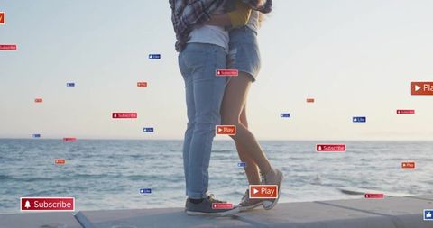Hugging couple on seawall by ocean horizon with floating subscribe play like icons
