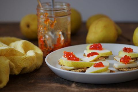 Pear and cheese snack with chili preserve on rustic table