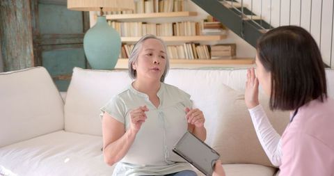 Senior Woman Speaking with Therapist During Home Session