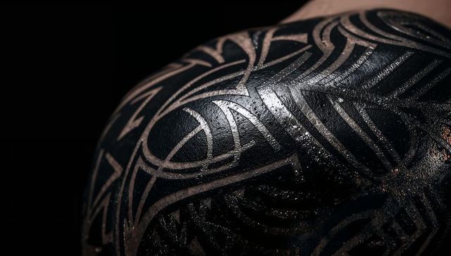Intricate tribal tattoo pattern on shoulder and back