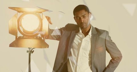 Sophisticated Man in Suit Illuminated by Stage Spotlight