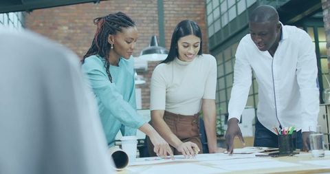 Diverse team focusing creative plans in modern office