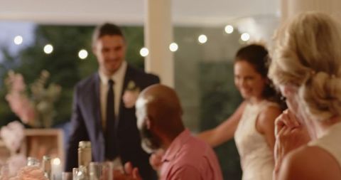 Joyful outdoor wedding celebration with string lights