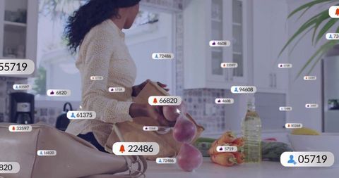 Unpacking Groceries in Sunlit Kitchen with Floating UI Labels Showing Social Metrics