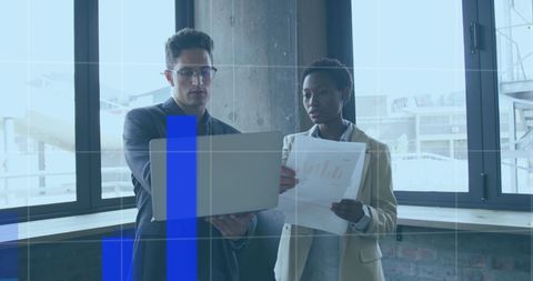 Diverse Business Team Analyzing Financial Data with Laptop