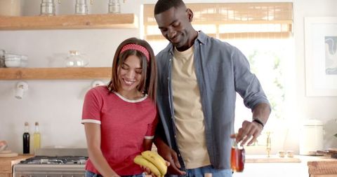 Couple Preparing Healthy Snack with Bananas and Honey in Kitchen