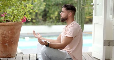 Man Meditating Outdoors by Poolside for Relaxation
