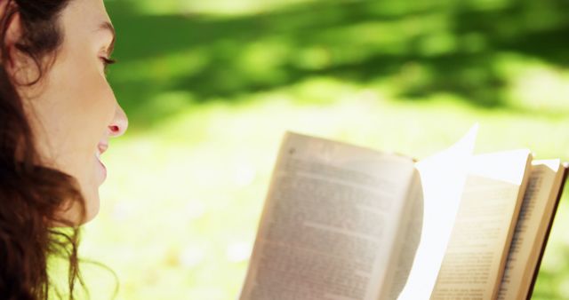 Woman reading book outside in sunny park - Download Free Stock Images Pikwizard.com