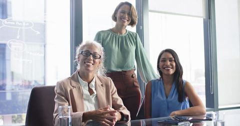 Businesswomen Smiling During Meeting in Modern Office - Download Free Stock Images Pikwizard.com