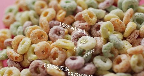 Macro closeup of colorful frosted cereal rings with numeric overlay and pink backdrop