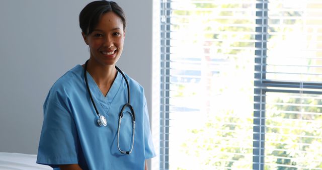 Smiling Female Nurse with Stethoscope in Bright Hospital Room - Download Free Stock Images Pikwizard.com