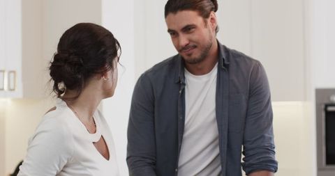 Couple Enjoying Meal Preparation in Modern Kitchen Together