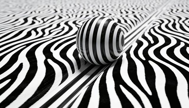 Concentric-striped sphere sitting on zebra-striped surface creating bold optical illusion