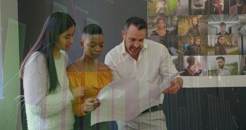 Team reviewing marketing strategy poster with data charts and portrait wall